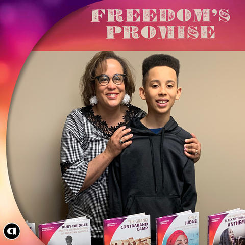 Photo of Duchess Harris and her son with a display of Duchess' books
